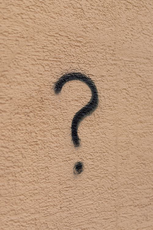 Question mark spray-painted on wall